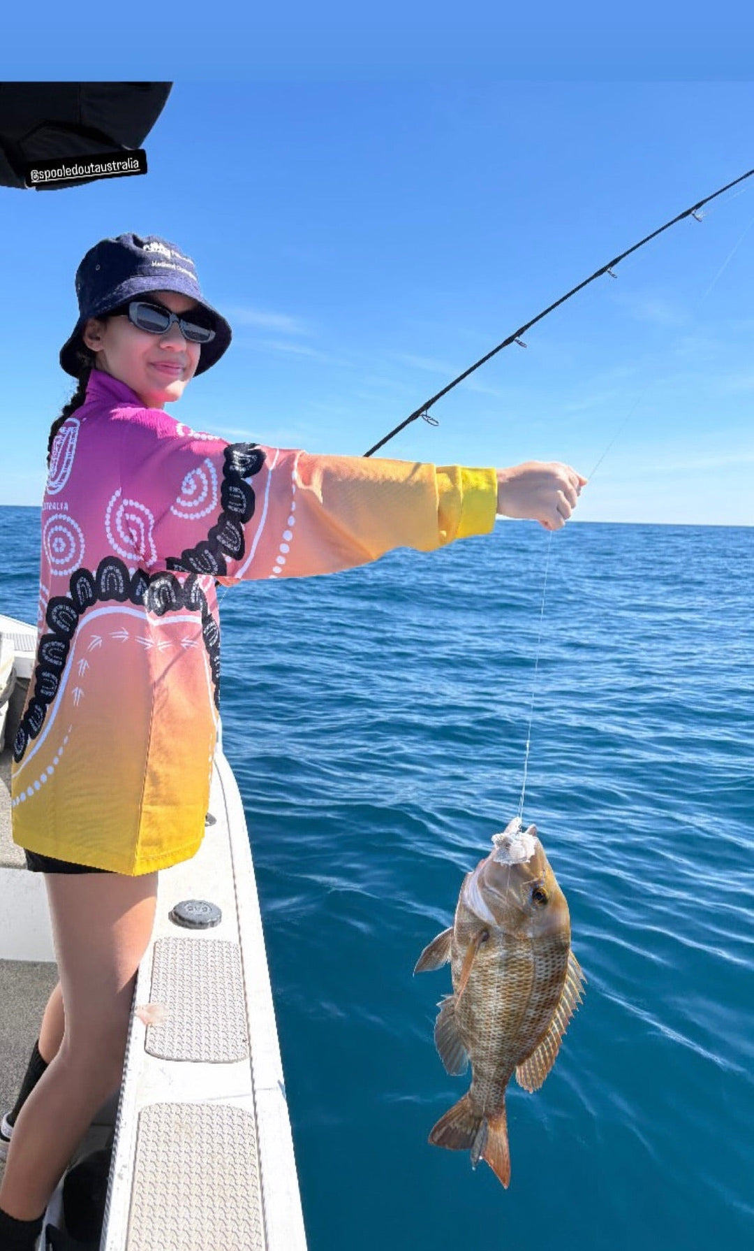 Angler safely releasing a fish back into Australian waters