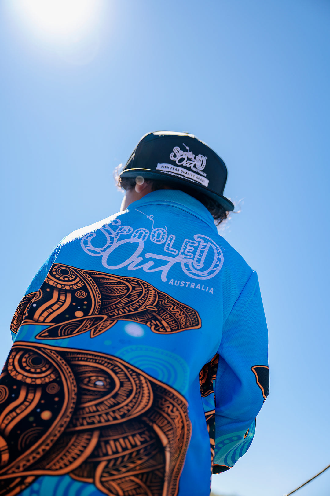 Dugong Migration Fishing Shirt - Back silhouette against bright blue sky