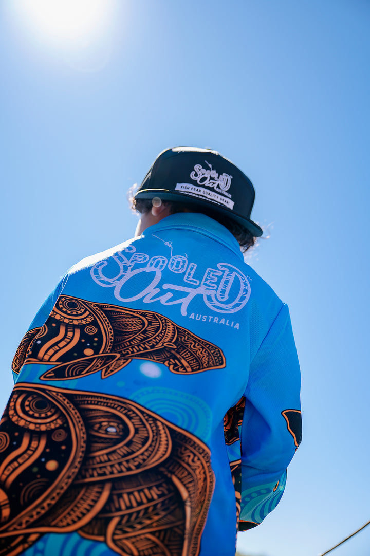 Dugong Migration Fishing Shirt - Back silhouette against bright blue sky