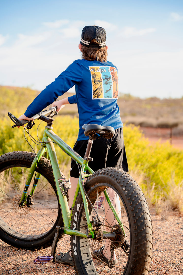 Pilbara Livin' Fishing Shirt - Boy on bike in yellow wildflowers, adventure lifestyle