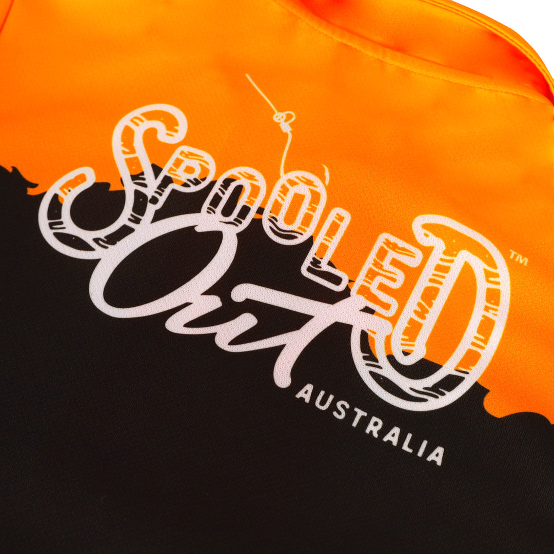Spooled Out Australia logo on an orange and black shirt up close